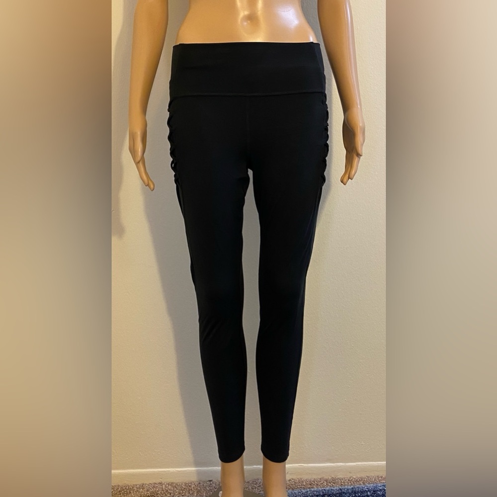 All In Motion Black Leggings w/ Decorative Criss Cross Pattern On Each Leg.